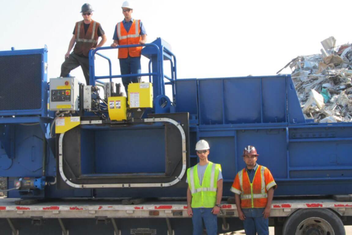 HSC technicians relocating a two-ram baler